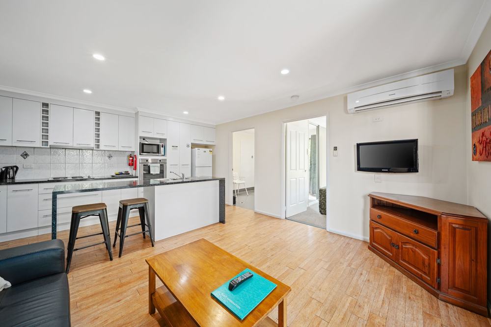 Open-plan living room and kitchen in a self-contained apartment